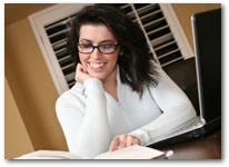 Woman reading book for online course