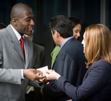 Man and woman networking at business function.