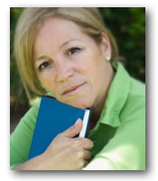 Woman with blue book smiling