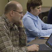 Adult students in class at University of Mary using laptops.
