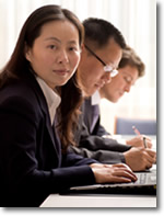 Learn More Today! Students studying at laptops at Kona University online